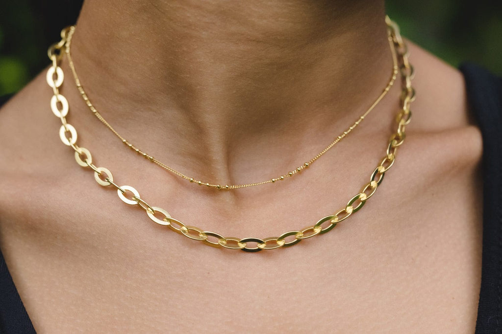 Champion Chain Studio Gold Necklace layered with Overtime gold necklace by Chelsea Charles