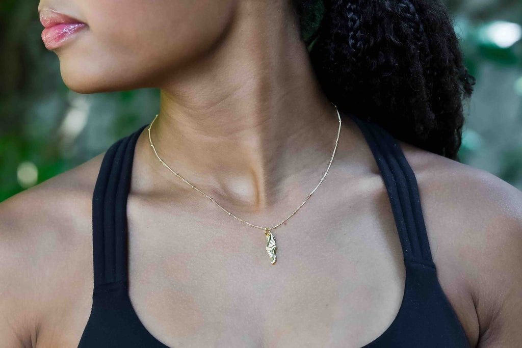 CC Sport Gold Track and Field Winged Track Shoe Charm Necklace With Crystal Shoe Lace Holes.