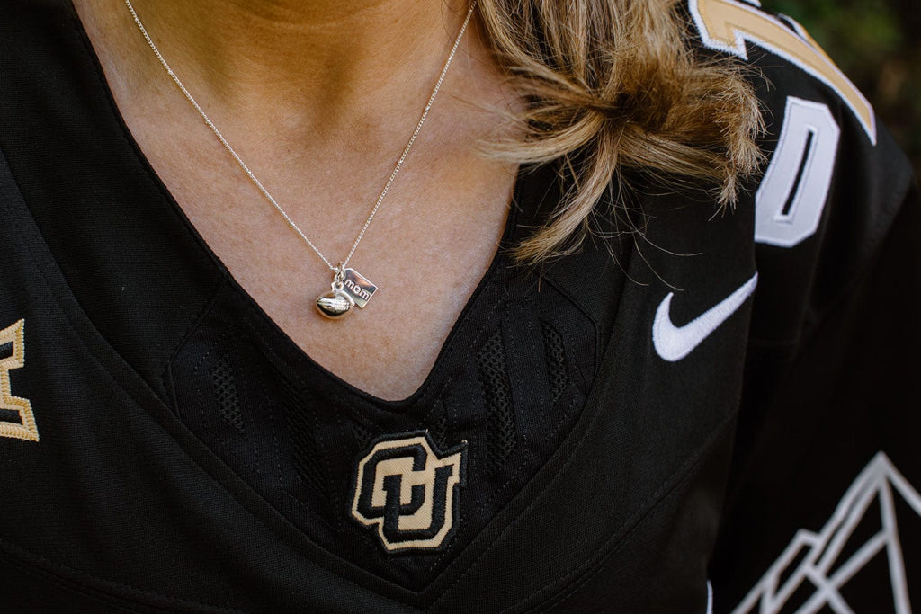 Mom wearing a football mom silver necklace by Chelsea Charles
