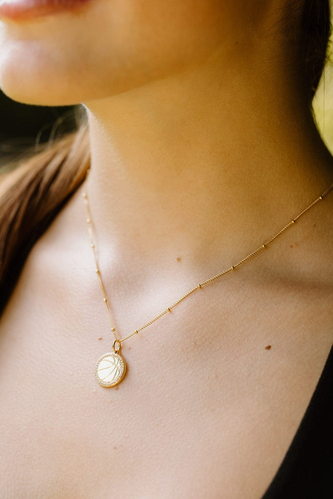 Model wearing Basketball gold necklace with clear crystals by Chelsea Charles 
