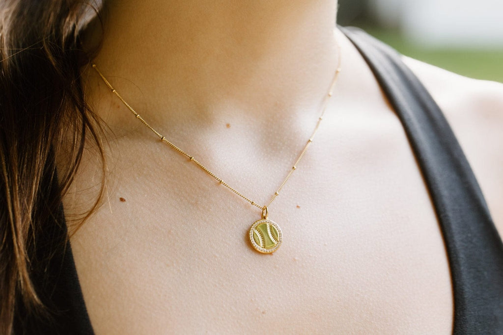 Gold softball necklace with pavé crystals by Chelsea Charles