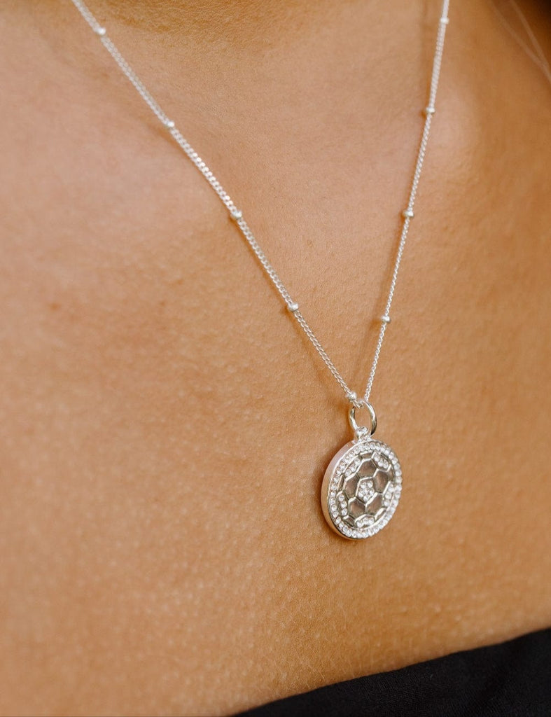 Close up of Silver and crystal soccer ball necklace by Chelsea Charles 