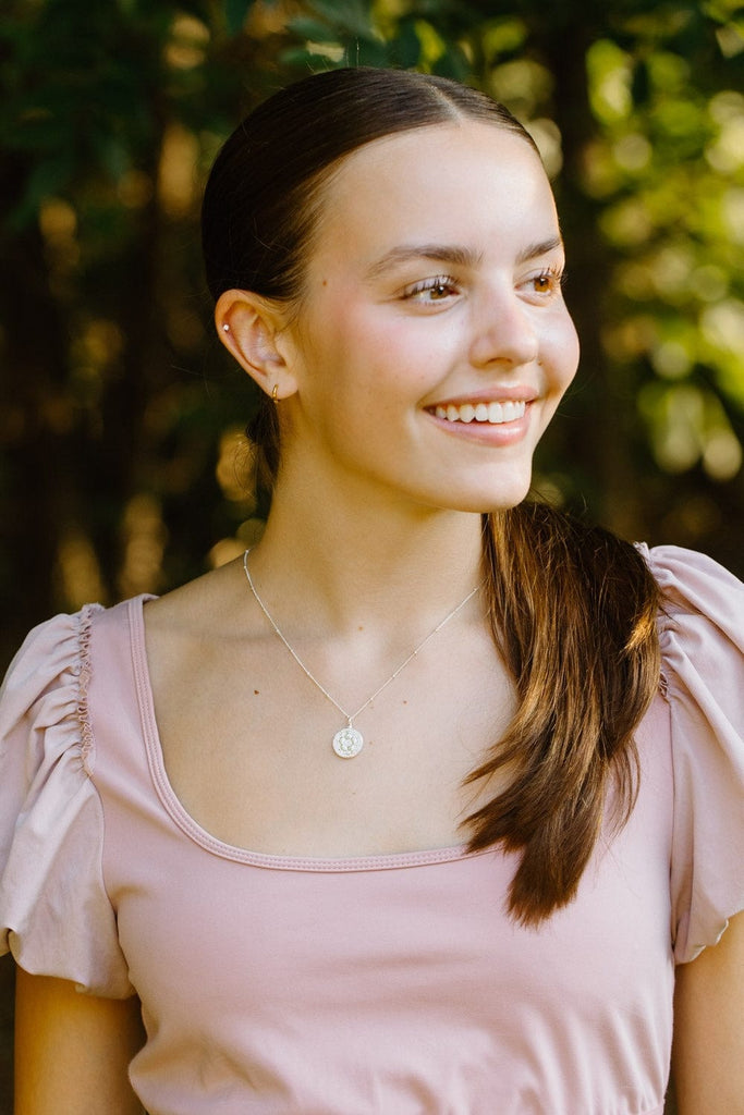 woman wearing silver pavé crystal soccer ball necklace by Chelsea Charles