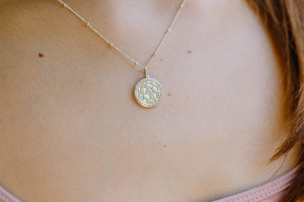 Detailed close up of silver pavé soccer ball necklace by Chelsea Charles