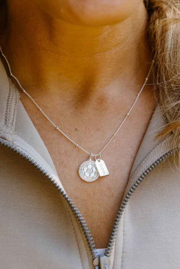 Silver pave soccer mom double charm necklace close up on model