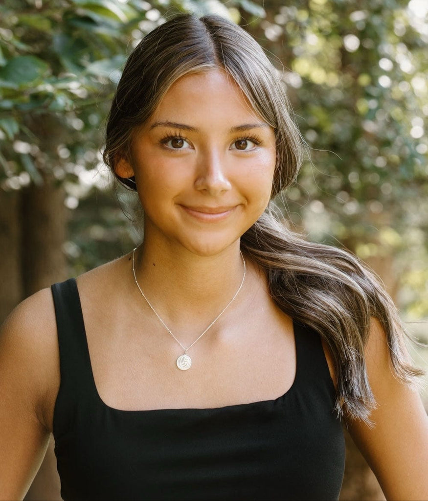 Girls wearing silver pave volleyball necklace by Chelsea Charles