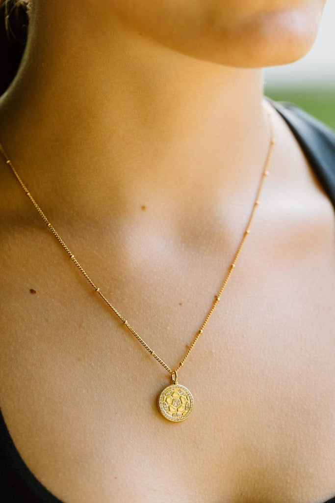 Gold pave soccer ball pendant necklace by Chelsea Charles
