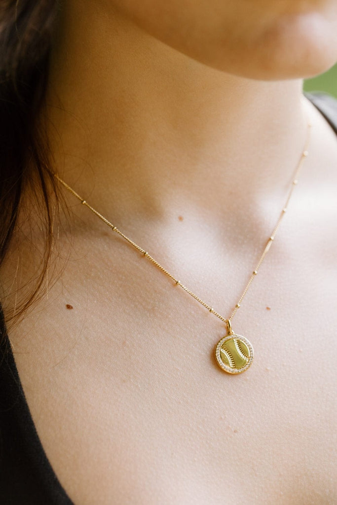 Gold softball necklace with pavé crystals by Chelsea Charles