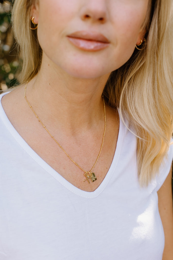 Close up of a mom wearing a gold mom lacrosse necklace