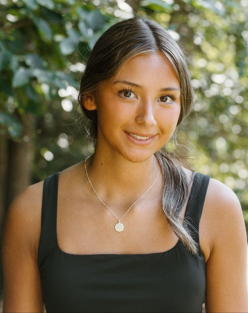 model wearing silver basketball necklace by Chelsea Charles